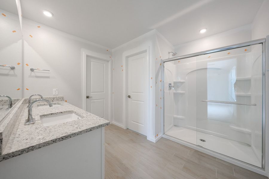 A bathroom with a glass shower. A bathroom with a glass shower.