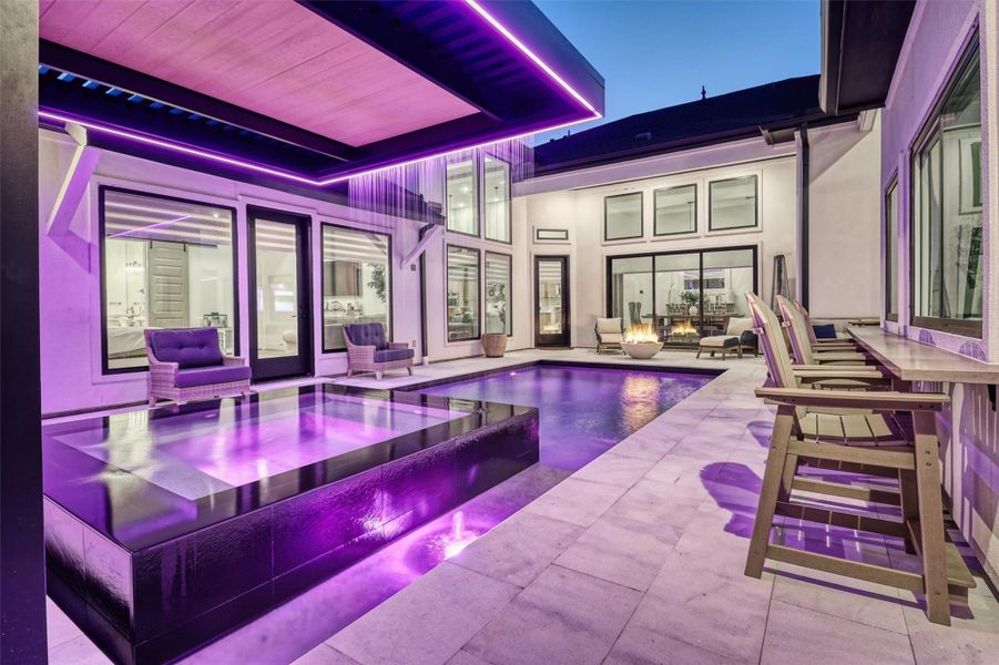 Pool features lighting that can be controlled with phone and coordinated with music. The waterfall over the infinity spa is designed to be truly one-of-a-kind! Pull up a chair at the bar and get first class service from the casita kitchen!