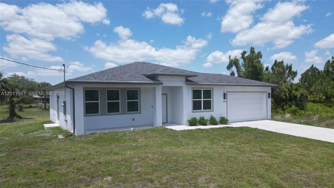 Front exterior of a new home in , Lehigh Acres, FL, highlighting curb appeal (Image 16). Front exterior of a new home in , Lehigh Acres, FL, highlighting curb appeal (Image 16).