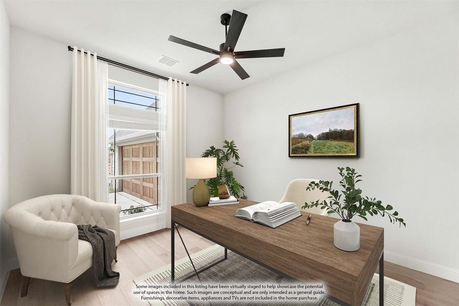Home office with wood desk, ceiling fan, hardwood floors, and large window with white curtains