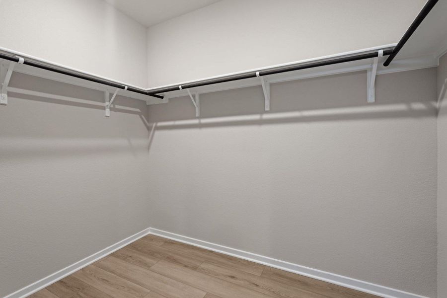 Walk-in closet in Primary Bedroom Walk-in closet in Primary Bedroom