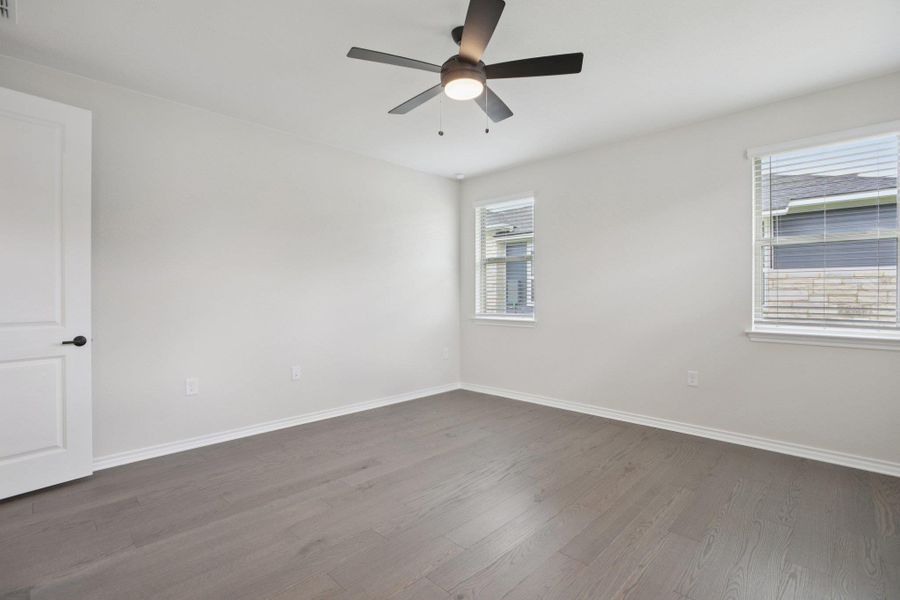 Empty room featuring wood finished floors and ceiling fan