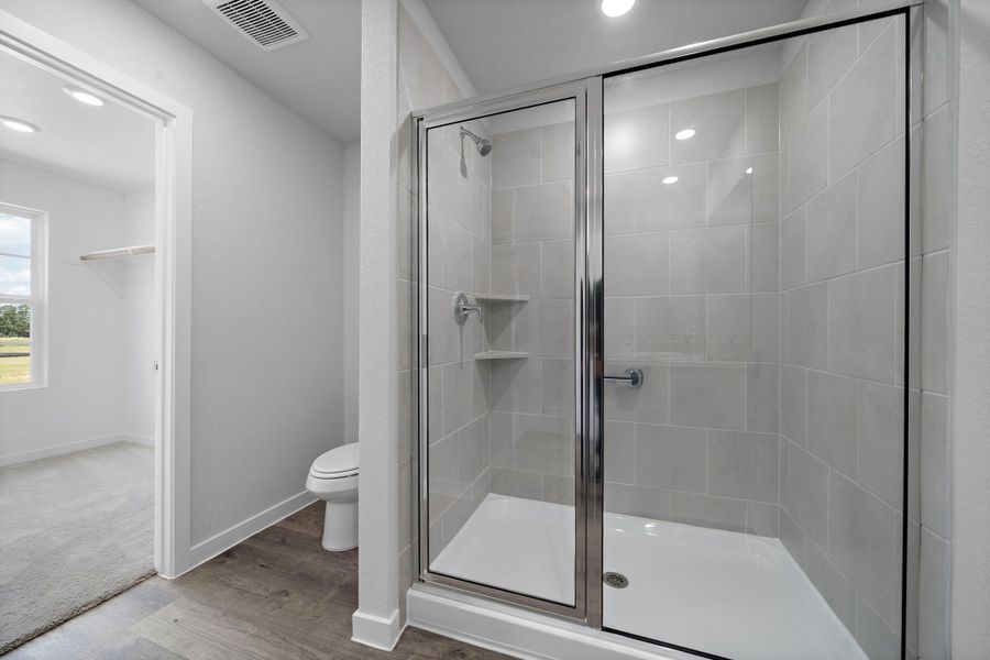 A bathroom with a glass shower. A bathroom with a glass shower.