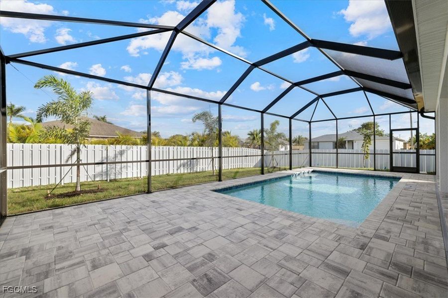 View of swimming pool featuring a fenced backyard, a sunroom, glass enclosure, and a patio View of swimming pool featuring a fenced backyard, a sunroom, glass enclosure, and a patio