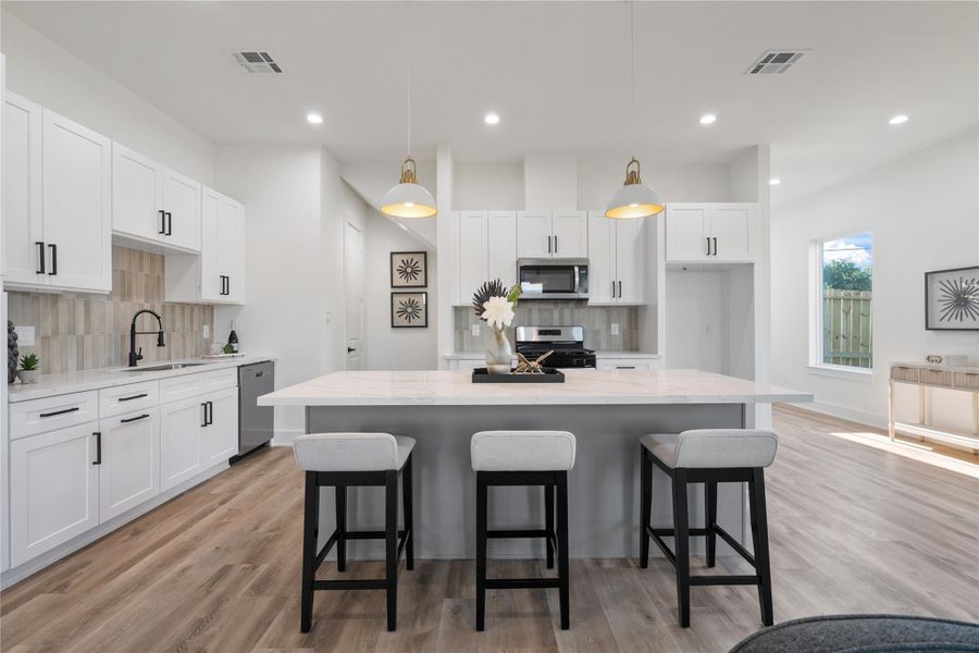 The kitchen island easily seats 3–4 people, making it perfect for casual meals, homework, or entertaining. Its generous size and functional design create a natural gathering spot in the heart of the home. This space balances practicality with modern farmhouse style effortlessly."