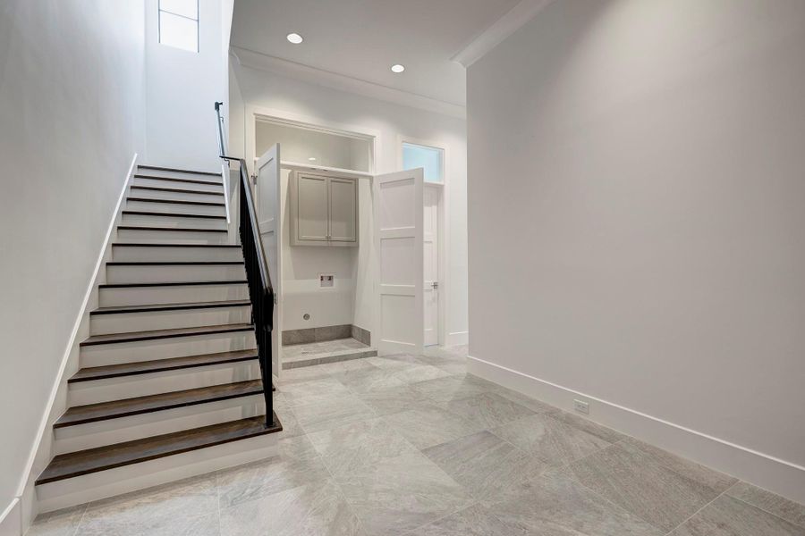 Another view of the mud room looking towards the staircase leading to the 2nd floor and the 1st floor utility room.