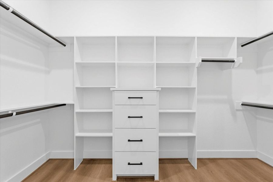 The walk-in closet you’ve been waiting for—complete with generous hanging space, shelving, and plenty of lighting.