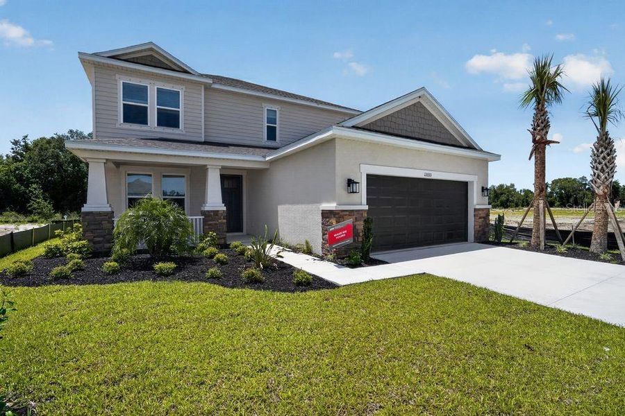 Front exterior of a new home in Firethorn, Parrish, FL, highlighting curb appeal (Image 21). Front exterior of a new home in Firethorn, Parrish, FL, highlighting curb appeal (Image 21).