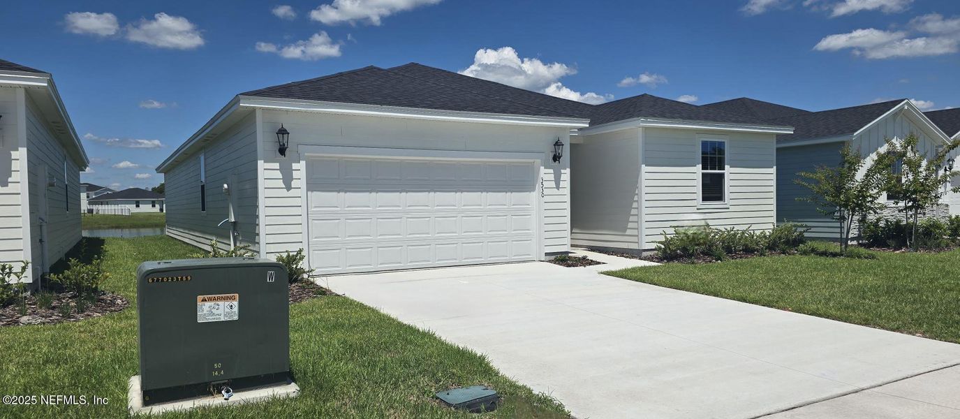 Front exterior of a new home in Lakes at Bella Lago - Signature Series, Green Cove Springs, FL, highlighting curb appeal (Image 20).