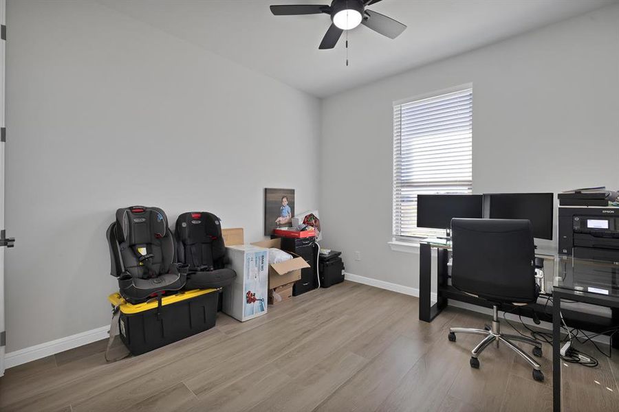 Office featuring wood finished floors, a ceiling fan, and baseboards