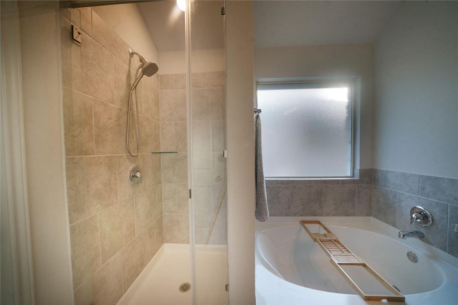 Full bathroom with a bath and a shower stall
