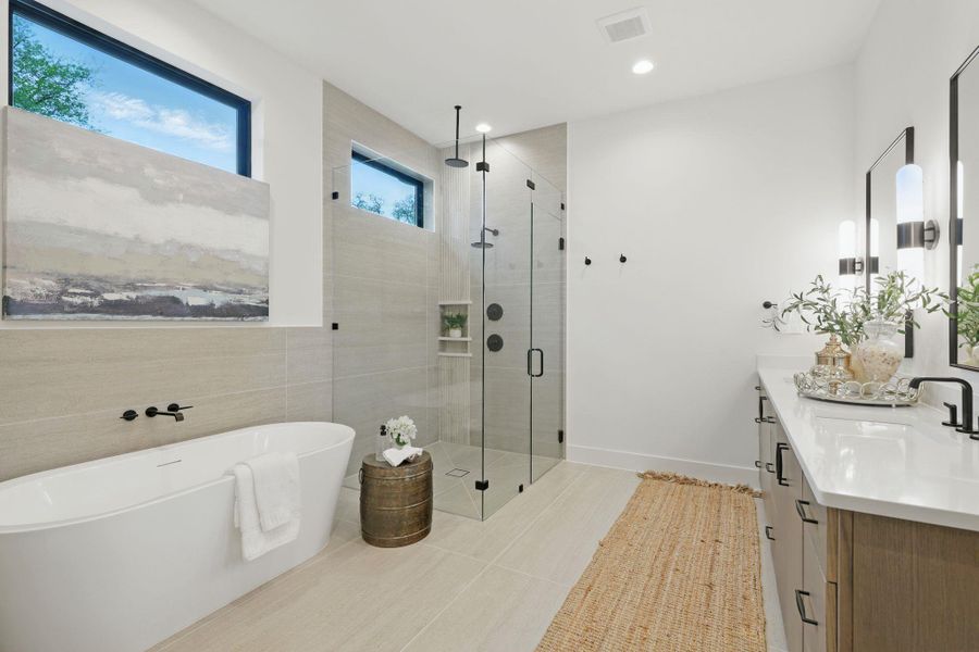 Bathroom with vanity, a stall shower, a soaking tub, tile walls, and recessed lighting
