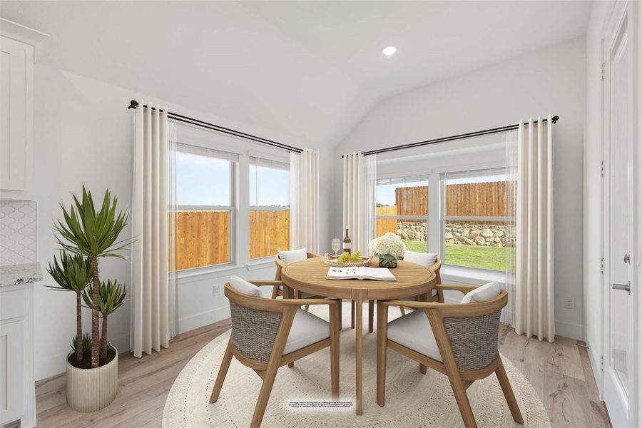 Bright breakfast nook with round wood table, four chairs, vaulted ceiling, and large windows overlooking backyard fence. Bright breakfast nook with round wood table, four chairs, vaulted ceiling, and large windows overlooking backyard fence.