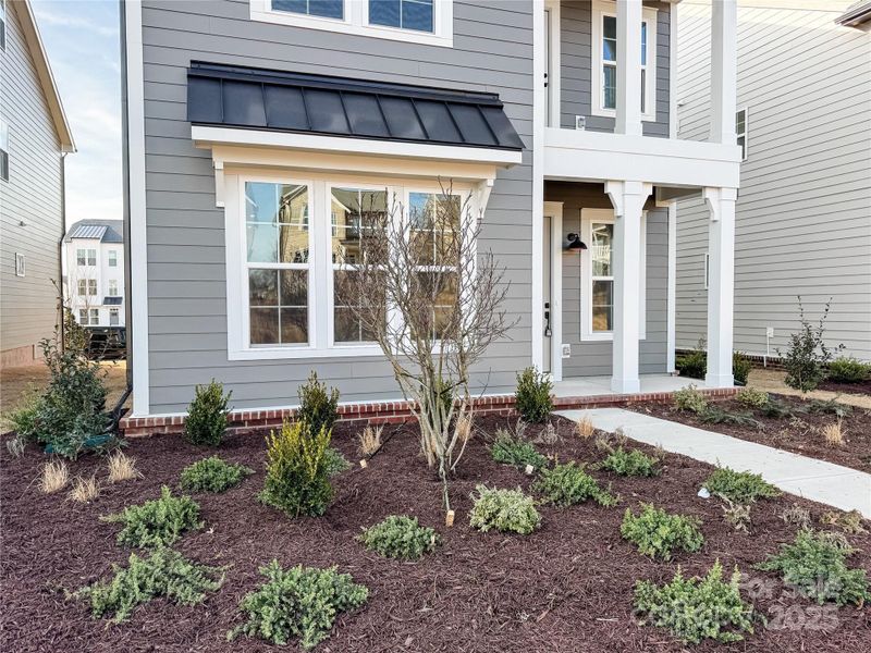 Exterior details and patio area of a home in The River District Townhomes, Charlotte (Image 3).