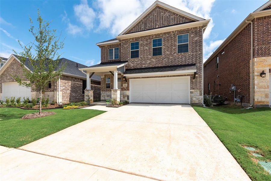 Front exterior of a new home in Spiritas Ranch, Little Elm, TX, highlighting curb appeal (Image 20).