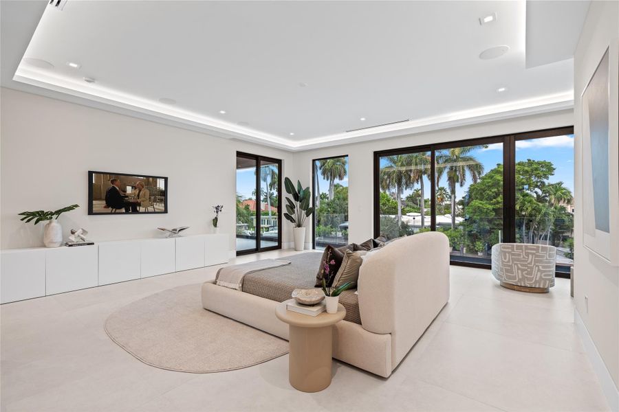 Expansive primary suite with floor-to-ceiling glass doors, waterfront views, and a sleek modern design with abundant natural light. Expansive primary suite with floor-to-ceiling glass doors, waterfront views, and a sleek modern design with abundant natural light.