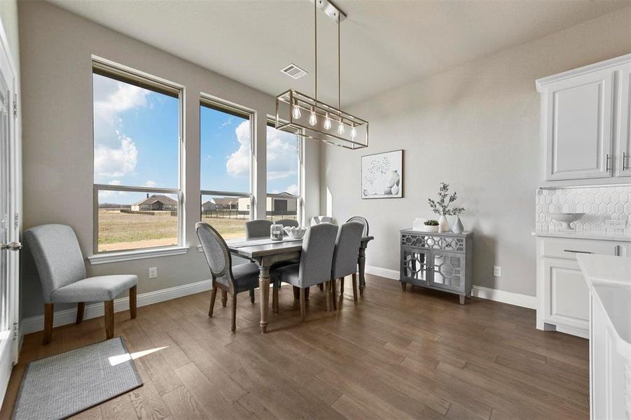 Dining space with dark wood-type flooring