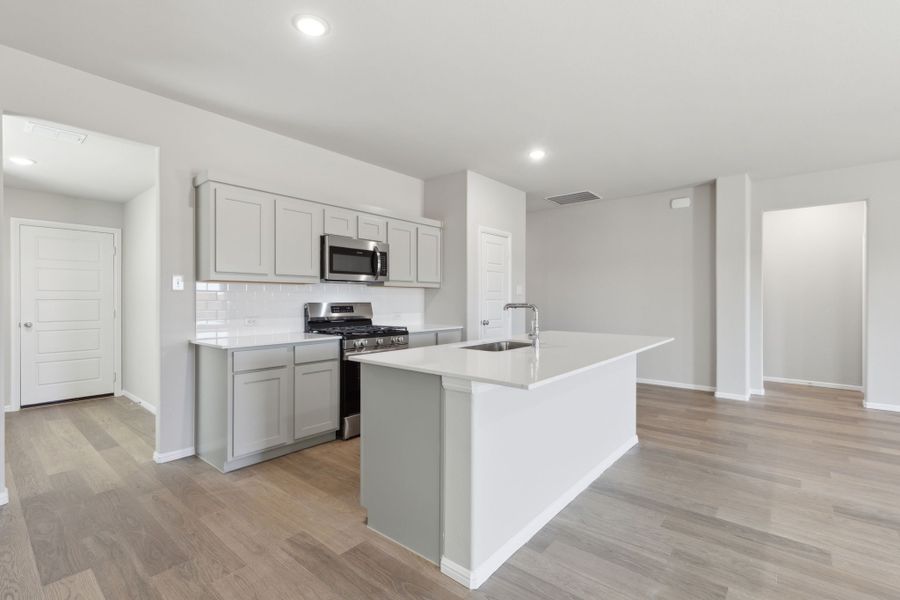 Kitchen in the Harrison home plan by Trophy Signature Homes – REPRESENTATIVE PHOTO