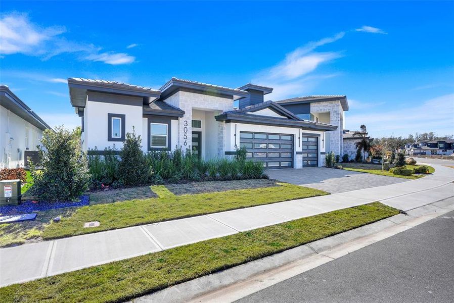 Front exterior of a new home in Hampton Green at Providence, Davenport, FL, highlighting curb appeal (Image 27).