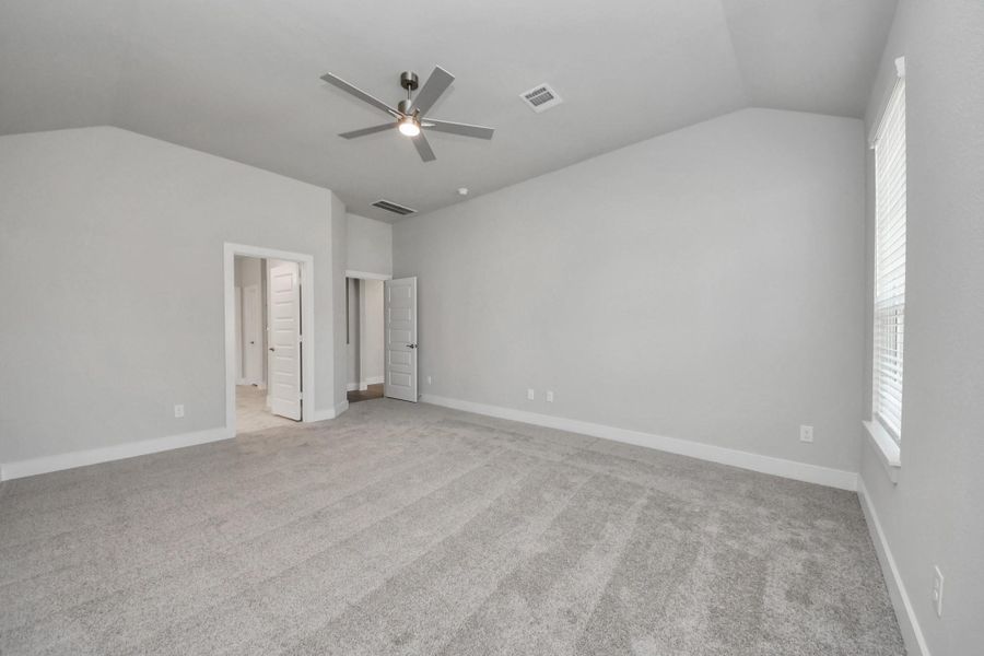 Come and unwind after a long day in this magnificent primary suite! This spacious room features plush carpet, warm paint, high ceilings and large windows with privacy blinds.