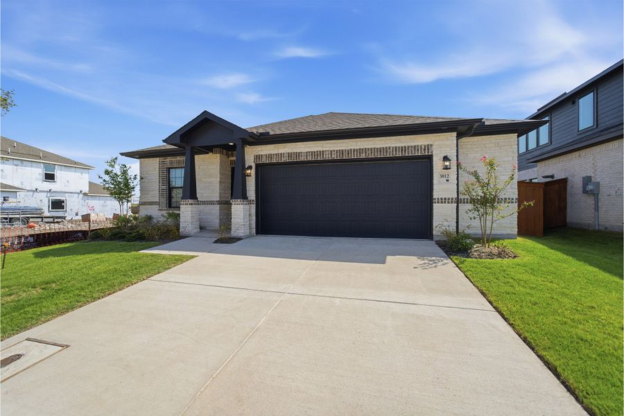 Front exterior of a new home in Heartland, Crandall, TX, highlighting curb appeal (Image 2).