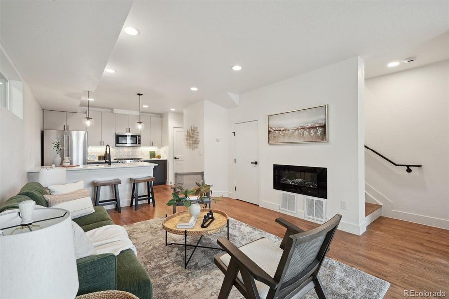 Open plan living, dining and kitchen, with half bath and coat closet on main floor