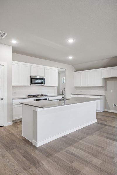 Kitchen in the Heisman home plan by Trophy Signature Homes – REPRESENTATIVE PHOTO