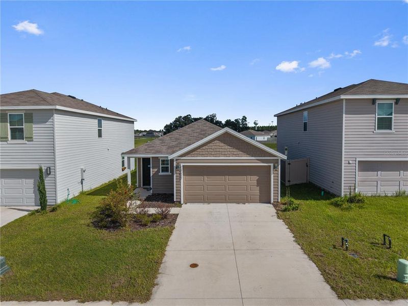 Front exterior of a new home in Avalon Woods, Newberry, FL, highlighting curb appeal (Image 27).