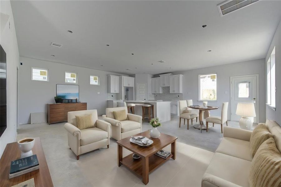 Step into this spacious, light-filled living area, where the open-concept design seamlessly connects the kitchen, dining, and living spaces. This versatile layout is perfect for family gatherings and entertaining guests, while the neutral color palette offers a modern, airy ambiance. **This image is from another Saratoga Home - Athena floorplan.**