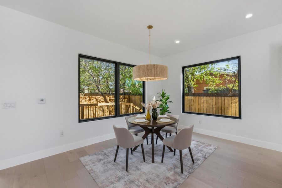 Dining room featuring plenty of natural light, light wood-type flooring, and recessed lighting