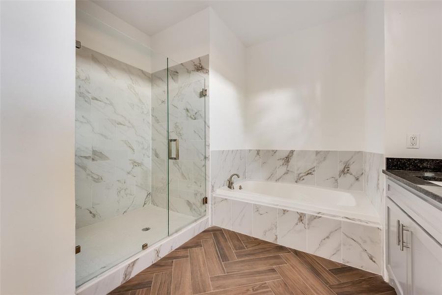 master bath with standing shower and bathtub