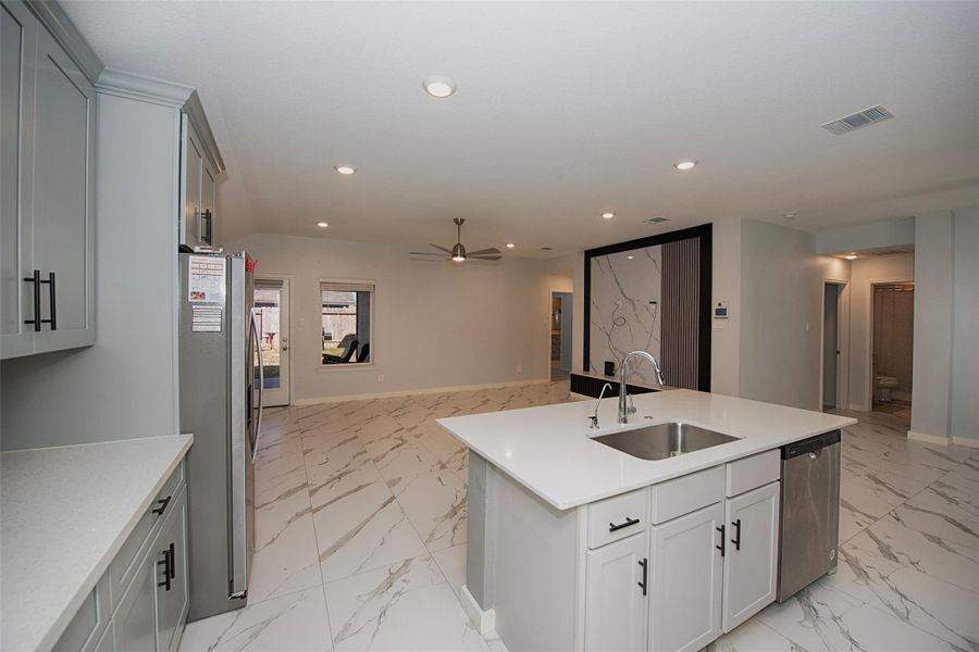 A view of the kitchen open to the family room. A view of the kitchen open to the family room.