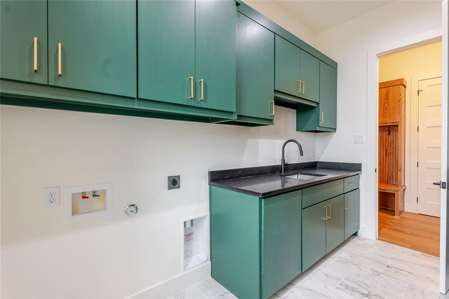 Laundry area featuring light marble finish floors, hookup for an electric dryer, hookup for a gas dryer, cabinet space, and hookup for a washing machine