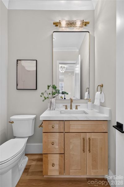 Half bath on main: 2" Calcutta quartz, Champagne plumbing fixtures, cabinet pulls and lighting! Porcelain tile flooring.
