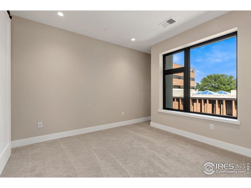 The second bedroom, with an east facing window, includes it's own full ensuite bathroom.