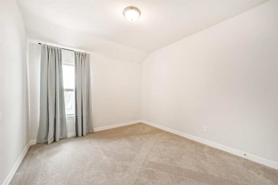 Guest bedroom number one offers plush carpet, designer paint, and a large window that floods the space with natural light. Guest bedroom number one offers plush carpet, designer paint, and a large window that floods the space with natural light.