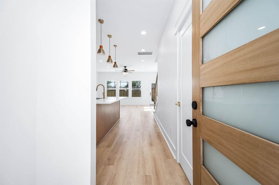 Welcoming entry view opening into a bright, open-concept living and kitchen area with modern finishes. Welcoming entry view opening into a bright, open-concept living and kitchen area with modern finishes.