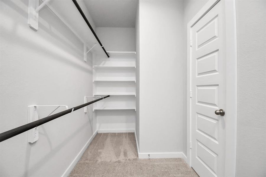 Walk in Closet with built in shelves. Sample photo of completed home with similar floor plan. Actual colors and selections may vary.