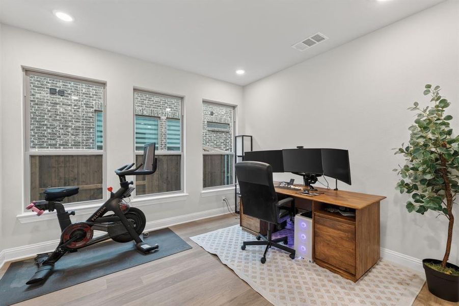 Home office with light wood finished floors and recessed lighting Home office with light wood finished floors and recessed lighting