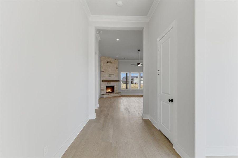 Hall featuring crown molding, light wood finished floors, and recessed lighting Hall featuring crown molding, light wood finished floors, and recessed lighting