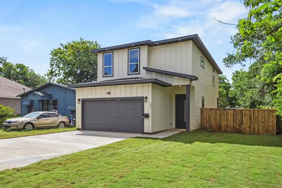 Contemporary two-story residence with vertical siding and dark trim accents Contemporary two-story residence with vertical siding and dark trim accents