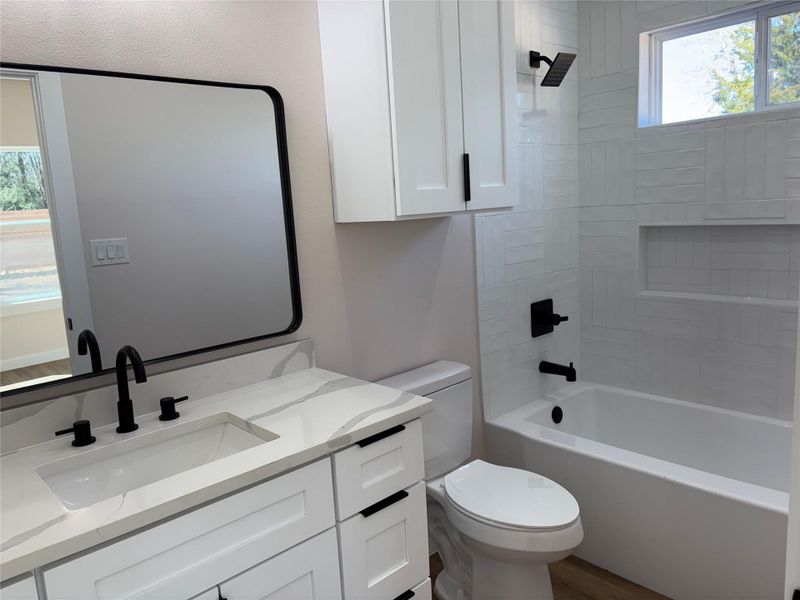 Bathroom with vanity and washtub / shower combination