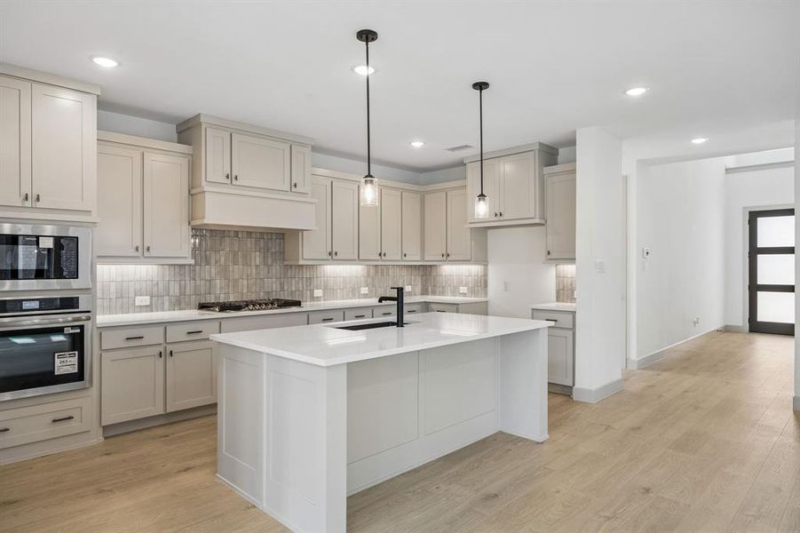You'll find thoughtful design elements like pull out trash, pot & pan drawers and walk in pantry throughout this chef's dream kitchen!