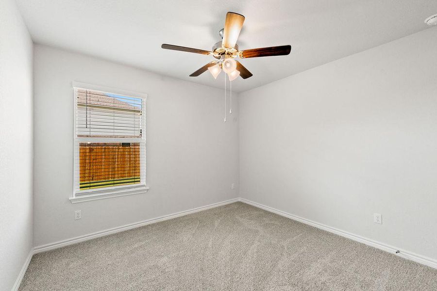 Unfurnished room with light carpet and a ceiling fan