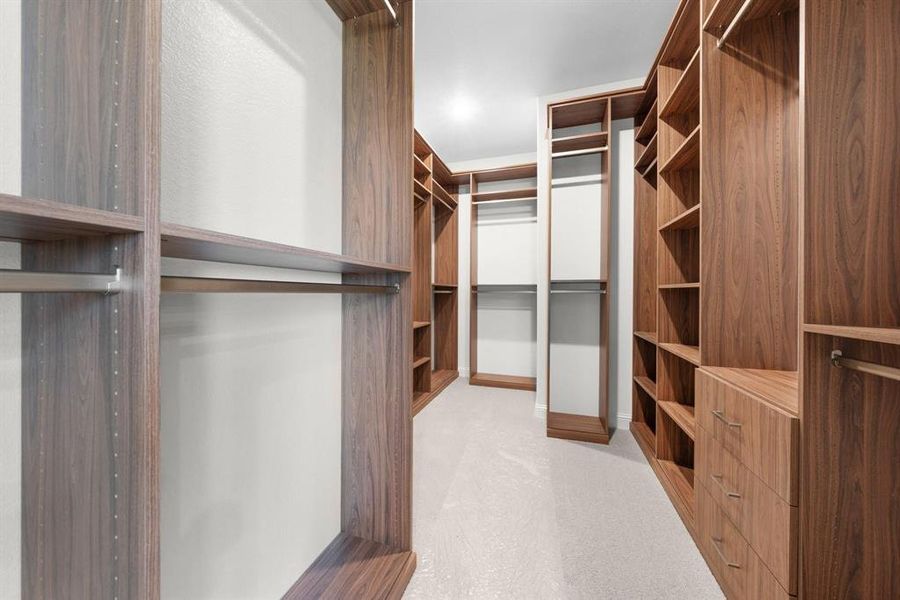 Primary bedroom features a large customized walk-in closet.