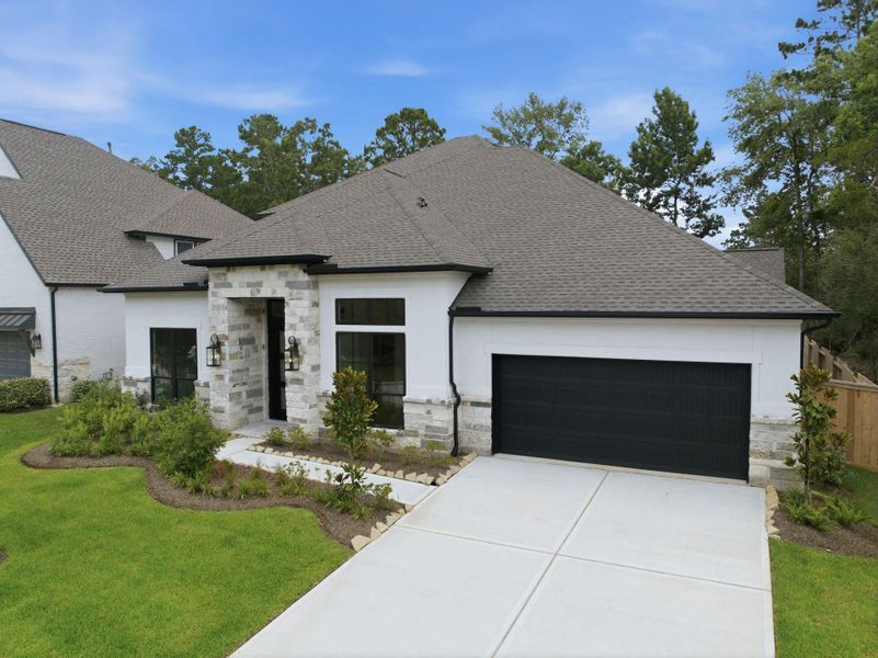 Front exterior of a new home in The Woodlands Hills 65′, Willis, TX, highlighting curb appeal (Image 29). Front exterior of a new home in The Woodlands Hills 65′, Willis, TX, highlighting curb appeal (Image 29).