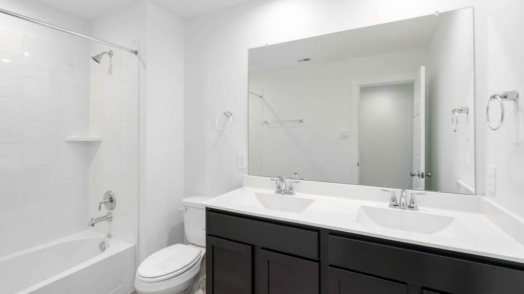 Representative furnished interior of a home built from the Jasmine by D.R. Horton in City Gate North, Houston (Image 6).