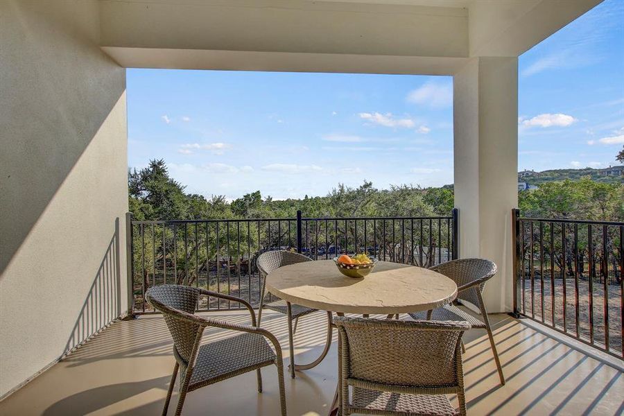 Balcony featuring a view of trees