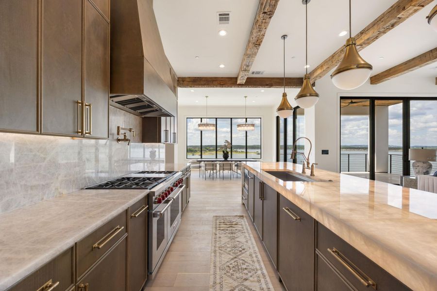 A well-appointed kitchen boasts sleek countertops, stainless steel appliances, and a captivating waterfront panorama. A well-appointed kitchen boasts sleek countertops, stainless steel appliances, and a captivating waterfront panorama.