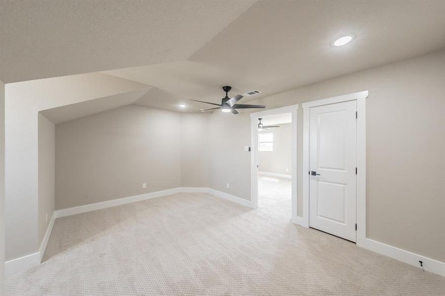Bonus room with light carpet, recessed lighting, lofted ceiling, and ceiling fan Bonus room with light carpet, recessed lighting, lofted ceiling, and ceiling fan